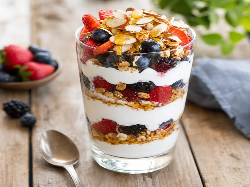 Finished Greek yogurt parfait with visible layers of yogurt, berries and granola ready to eat