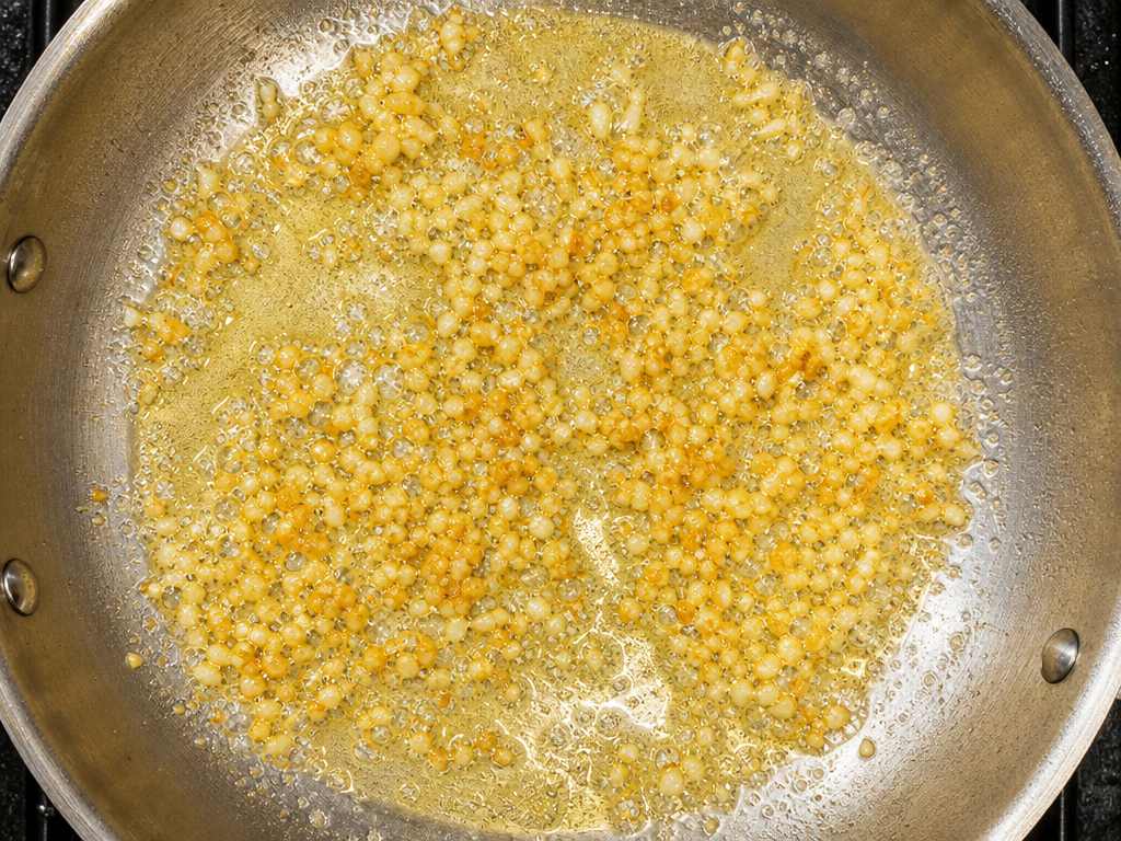 Sautéing minced garlic in butter